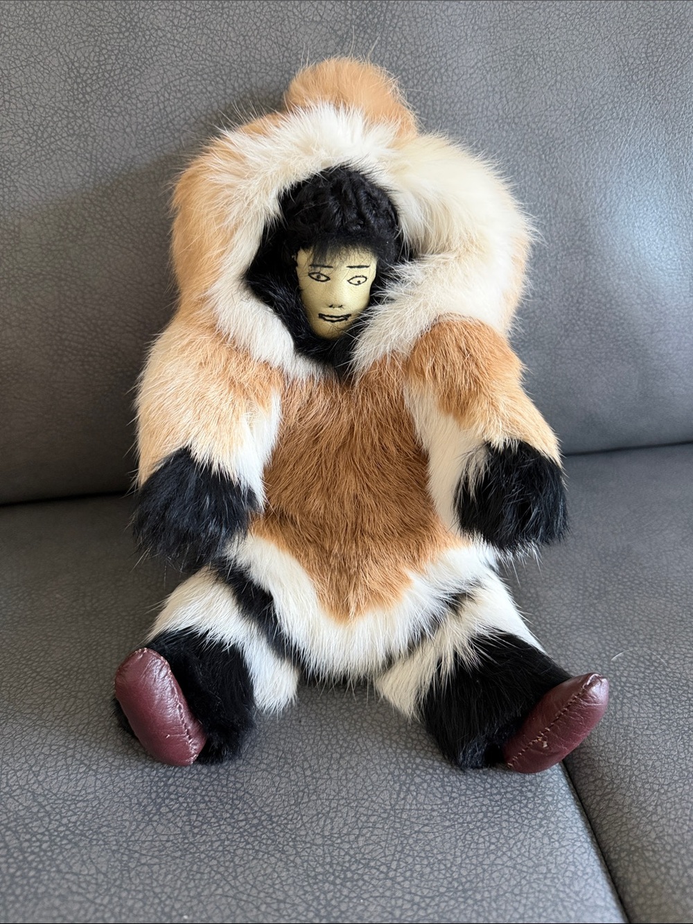 Handmade Alaskan Camai fur doll with painted face and fur clothing.